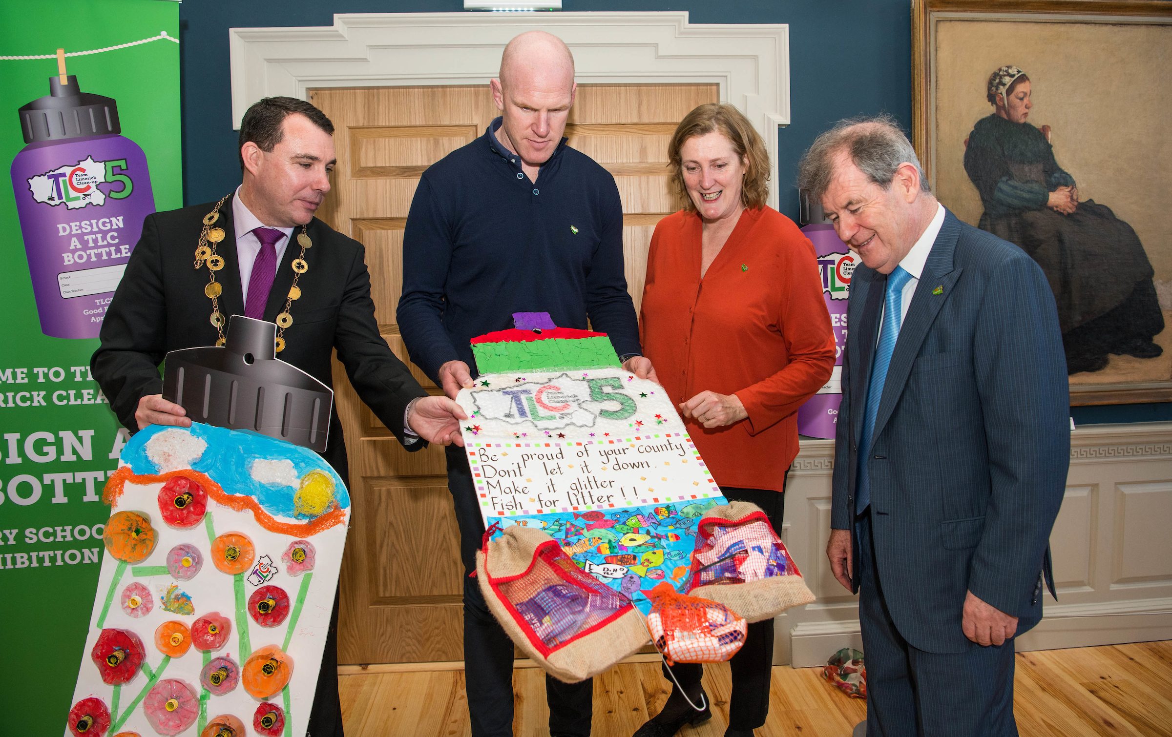 07/03/2019Mayor of Limerick City and County, Cllr James Collins, Paul O'Connell, Helen O'Donnell and JP McManus look closely at a poster design by 6th class students from Knocklong NS today at the 'Design a TLC Bottle' prizegiving at the Hunt Museum, Limerick. Over 50 primary schools across the county entered ahead of Team Limerick Clean-Up 5, which will see thousands of volunteers take to the streets of Limerick city and county for Europe's largest one-day clean up. Sponsored by the JP McManus Benevolent Fund, the event has seen over 360 tonnes of litter gathered from the streets since inception in 2015. Over 14,000 volunteers have already signed up for the 2019 event, taking place on Good Friday, 19th April. Photo by Diarmuid Greene